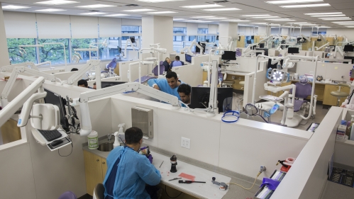 Dental students and providers work in the school's clinic