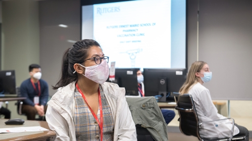 Rutgers Vax Corps members listen to a training about administering vaccines