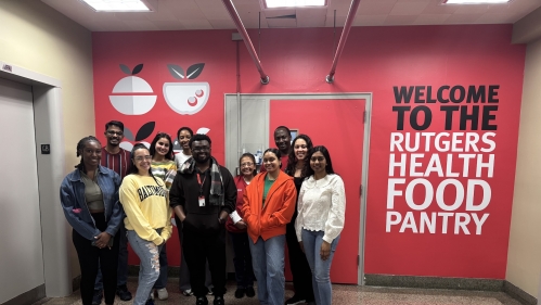 Staff standing in a group in front of the entrance to the pantry