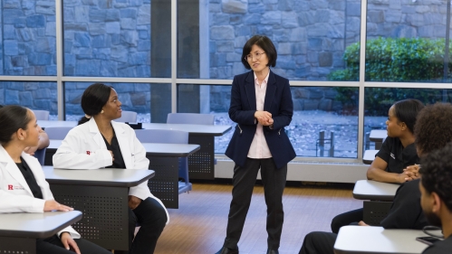 An instructor talks to nursing students in a lecture room
