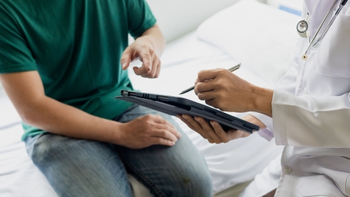 doctor screens sitting patient