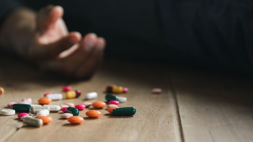 Pills near an empty hand after suicide