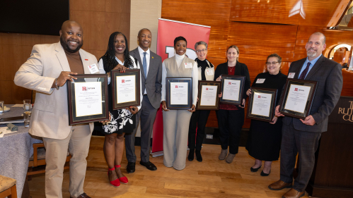 President William F. Tate IV stands with Advocacy, Outreach, & Support (DOS-AOS) team PEER Honorees for the Rutgers Gateway Award (Service to Students) (l. to r.) Halston Fleming, associate dean for case management, Pamela Harris, Office Manager and Administrative Assistant, Victoria Miller-Butcher, Assistant Dean for case management, Elizabeth O'Connell-Ganges, associate dean for student success, Lauren Kerton, senior coordinator, Sandra (Rocio) Castro, associate dean of students, Jeff Broggi, senior assoc