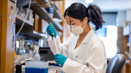 A student uses a pipette in a lab