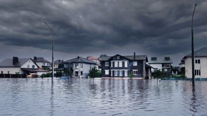 Dark storm clouds hang over a flooded neighborhood