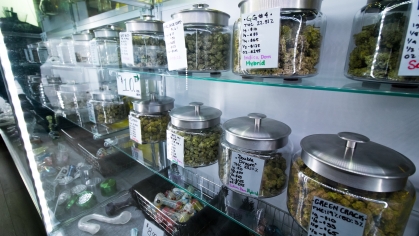 Jars of medical cannabis sit on shelves in a dispensary