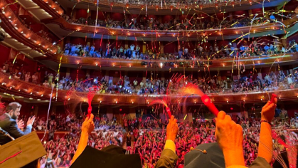 Graduates throw streamers in the air during convocation at the NJ Performing Arts Center in New Brunswick