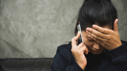 Depressed person making a phone call
