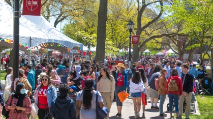 Throngs of visitors walk along Voorhees Mall on College Avenue during Rutgers Day 2022.