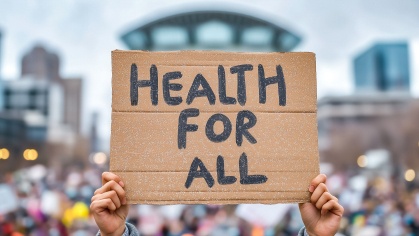 protestor holds "Health for All" sign