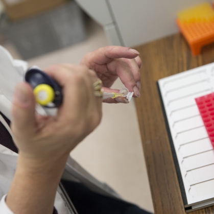 Pipetting blood samples in the Bio Specimen Repository at CINJ.