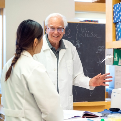 Researchers talk in a lab at the Center for Advanced Biotechnology and Medicine