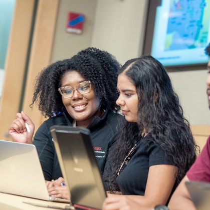 School of Graduate Studies students work on a laptop 