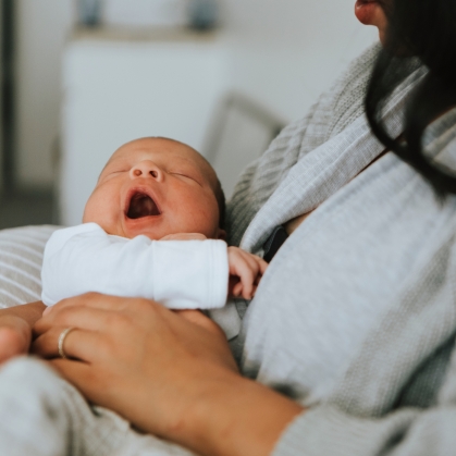 A mother holds a newborn