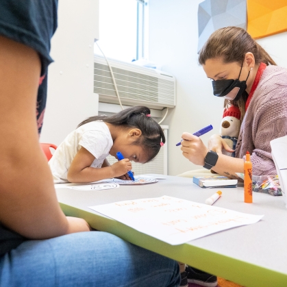 Students work with a patient in the speech language pathology clinic