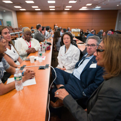 Participants talk in groups at the Integration Summit 