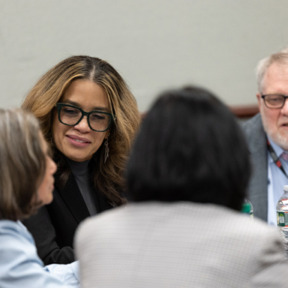 Attendees talk in groups at the integration summit.