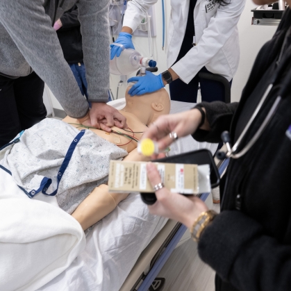 Medical students work together in a simulation lab.