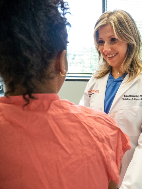 A Rutgers Health provider speaks with a patient in an exam room