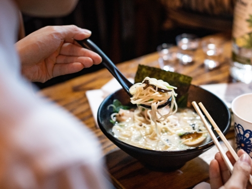 Person eating ramen