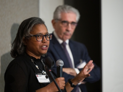 Two speakers give a presentation during the integration summit