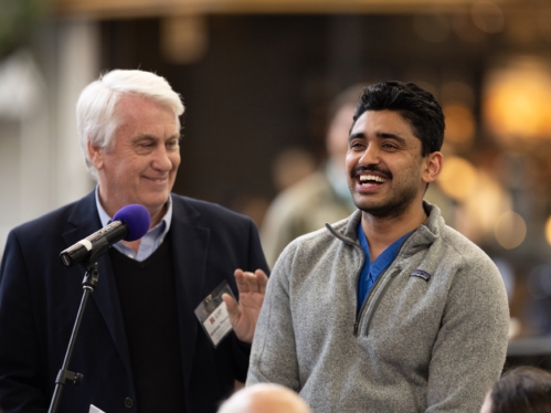 A student and faculty member stand at a microphone during the integration meeting at RWJMS 