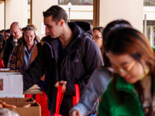 Patrons picking up food from a mobile food drive event