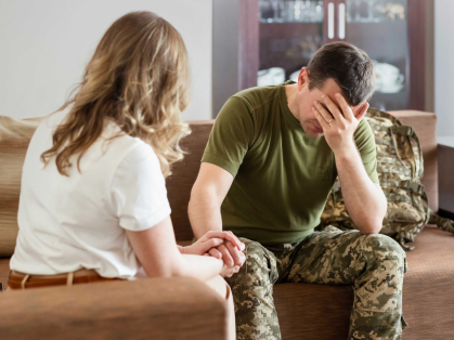 Sad Veteran with family member