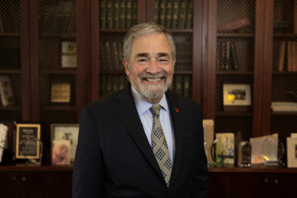 Inaugural Chancellor Brian Strom stands in his office
