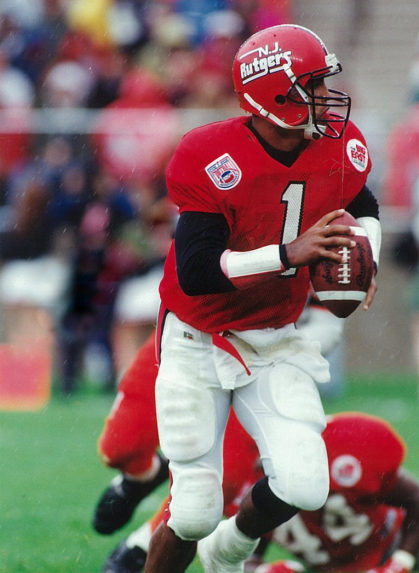 Ray Lucas is shown in his Rutgers gear on the field holding a football