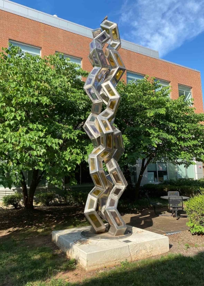 "Synergy" stands outside the Proteomics Building on Busch campus at Rutgers-New Brunswick.
