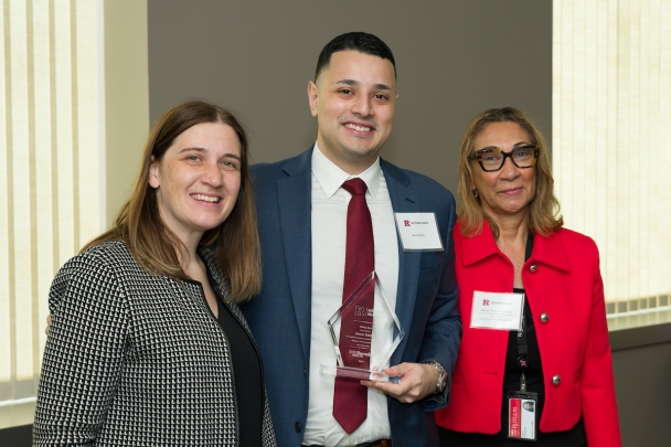 Faculty and a student smiling at the Rising Stars Ceremony
