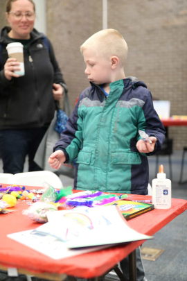 Gregory, 6, of Old Bridge Township, N.J., decorates a paper R in the College Avenue Student Center during Rutgers Day 2026.