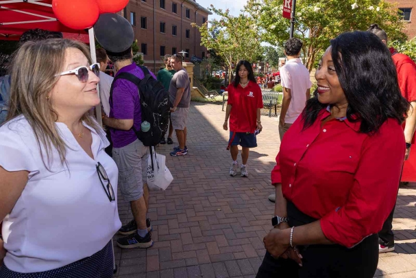 Gabrielle D. Cahill (left), a councilwoman for the Township of Piscataway, chats with Rutgers-New Brunswick Chancellor Francine Conway.