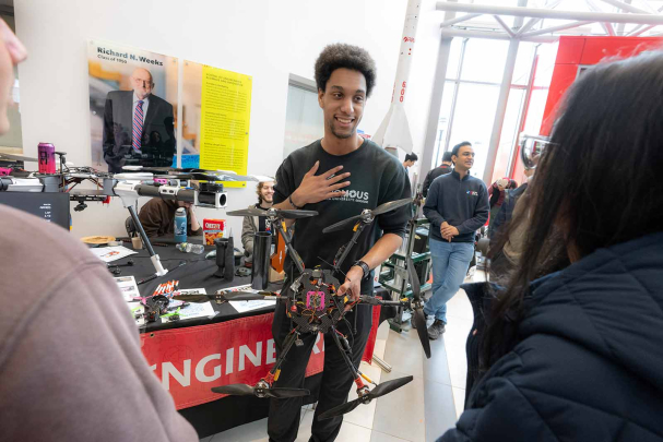 Engineering student Mason Diaz answers questions about drones inside the Richard L. Weeks Hall of Engineering during Rutgers Day on Busch campus.