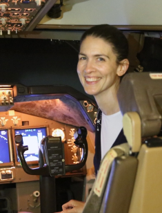 Dr. Erin Flynn‑Evans of NASA Ames Research Center, sits in a flight simulator cockpit